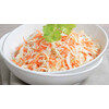 Portion of white cabbage salad with carrots and raisins